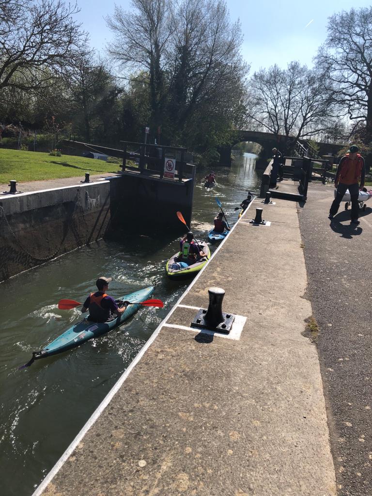 The group of kayakers leaving the lock after it opens