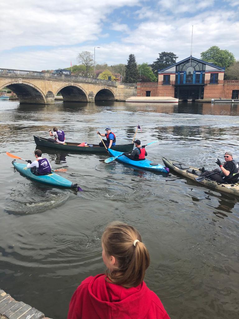 A group of Kayakers set off again after a short break and head toward a bridge